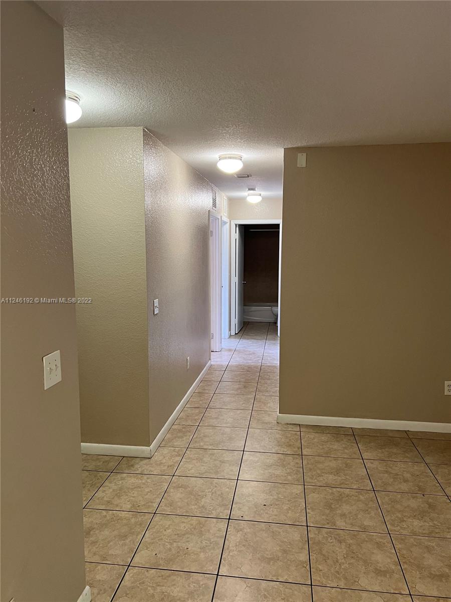 3837 Northwest 76th Way Davie, FL 33024 - Photo 23 of 34 a view of hallway with a window and a bathroom