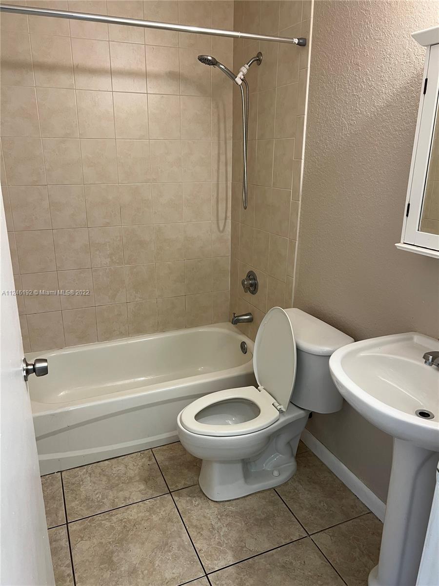 3837 Northwest 76th Way Davie, FL 33024 - Photo 26 of 34 a white toilet sitting next to a bath tub