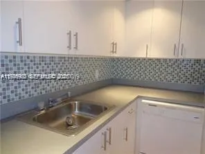 a close view of a sink a faucet and appliance in the bathroom