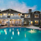 a front view of a building with swimming pool and seating space