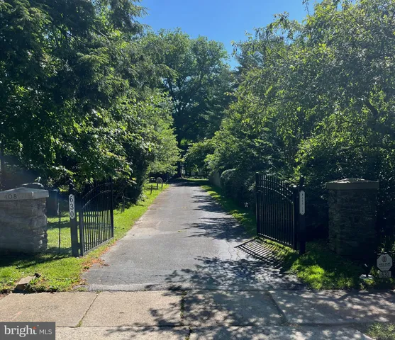 a view of a house with a chairs and table in a yard