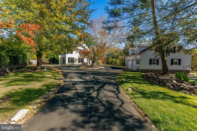 a living room with furniture a fireplace and wooden floor