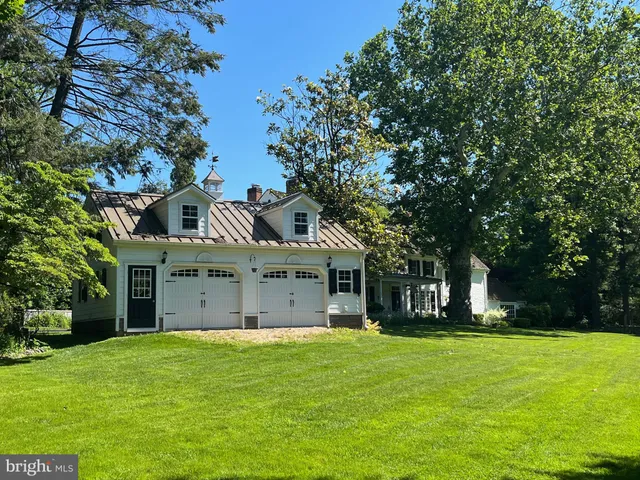 a large kitchen with stainless steel appliances granite countertop a lot of counter space and wooden floors