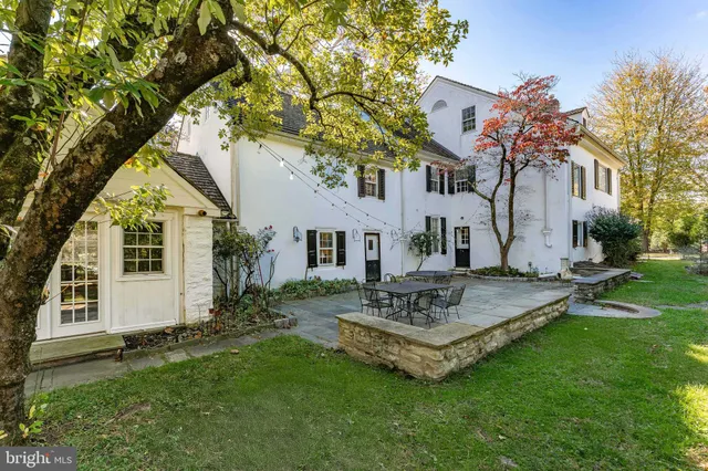 a kitchen with stainless steel appliances granite countertop a sink dishwasher a stove and white cabinets with wooden floor