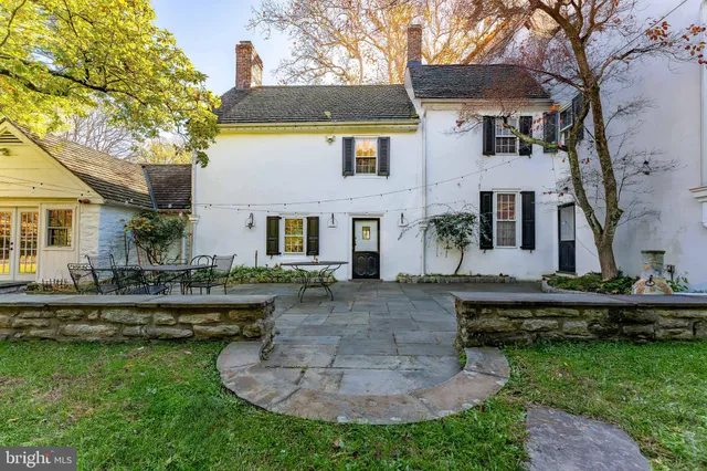 a kitchen with stainless steel appliances granite countertop a stove a refrigerator a kitchen island a hardwood floor and a sink