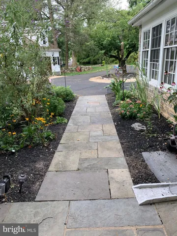 a kitchen with granite countertop a white cabinets and wooden floor