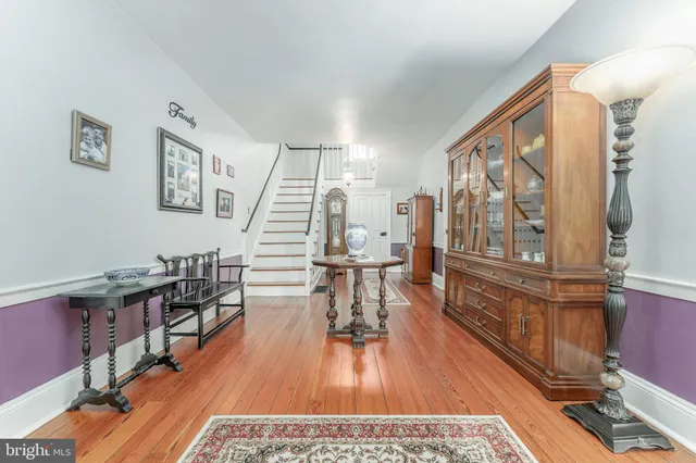 a living room with furniture a rug and a flat screen tv