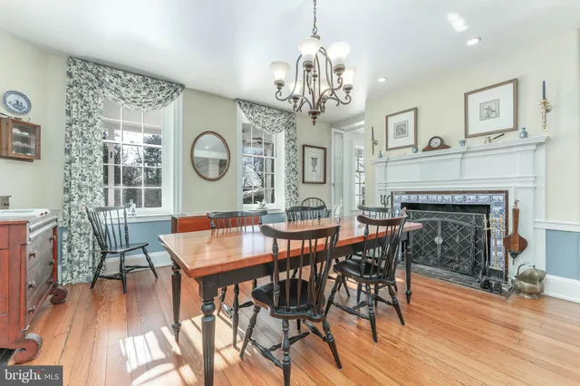 a living room with furniture a fireplace and a table