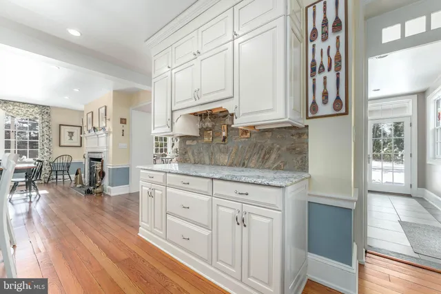 a bedroom with a large bed a flat tv screen and a dresser