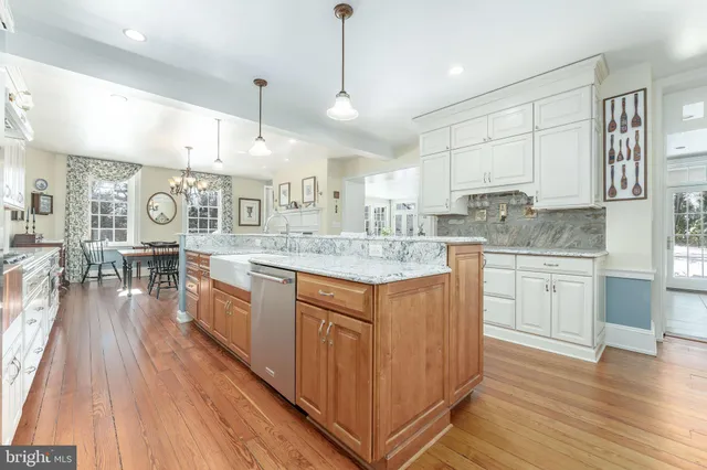 a bathroom with a sink vanity granite tub and a mirror