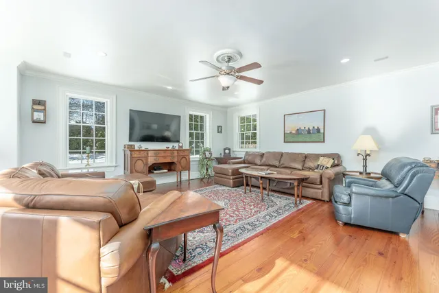 a spacious bedroom with a bed and wooden floor