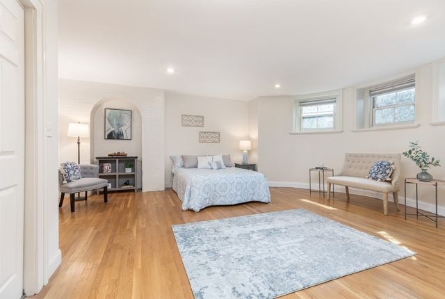 a bedroom with furniture and a wooden floor