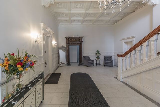 a lobby with furniture and flowers