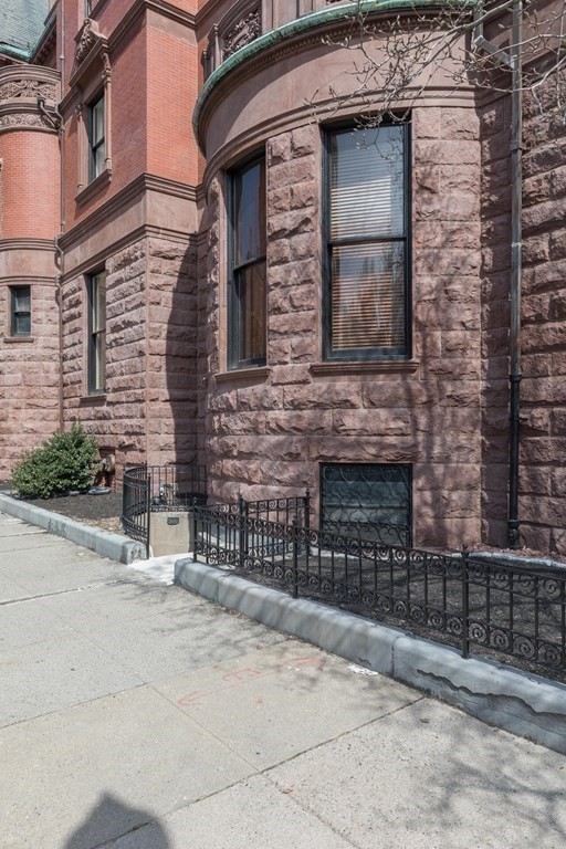 17 Gloucester Street, Unit A Boston, MA 02116 - Photo 18 of 20 front view of a brick house with a small yard