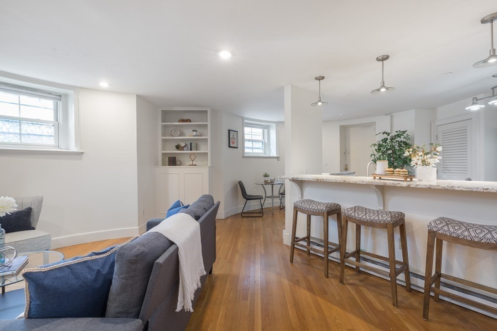 17 Gloucester Street, Unit A Boston, MA 02116 - Photo 5 of 20 a living room with furniture and a wooden floor