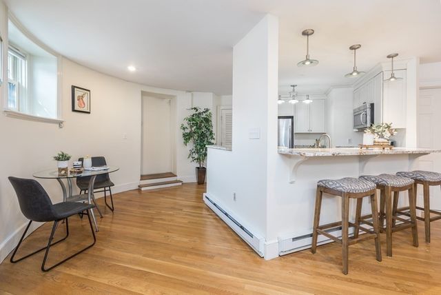 a view of kitchen with cabinets and wooden floor