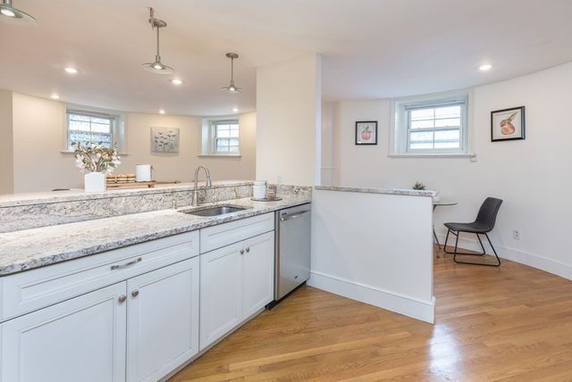 a spacious bathroom with a granite countertop sink and a mirror