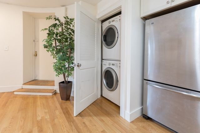 a view of a hallway with washer and dryer