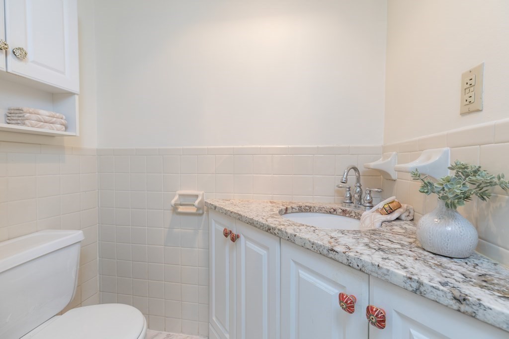 17 Gloucester Street, Unit A Boston, MA 02116 - Photo 10 of 20 a bathroom with a granite countertop toilet sink and mirror