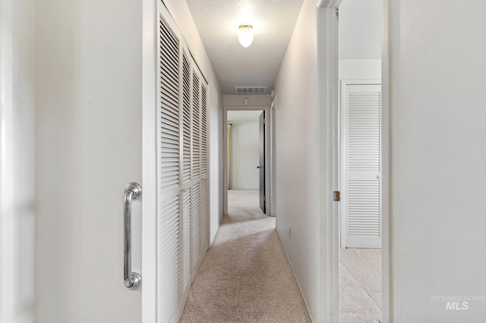 11360 West Lake Hazel Road Boise, ID 83709 - Photo 27 of 50 White louvered bifold closet doors with round knobs