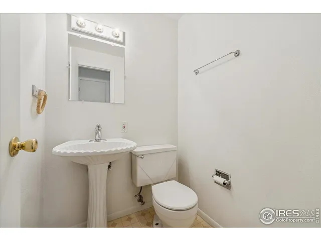 a bathroom with a sink toilet and mirror