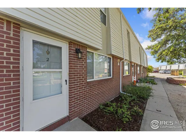 a view of a house with a yard and sitting space