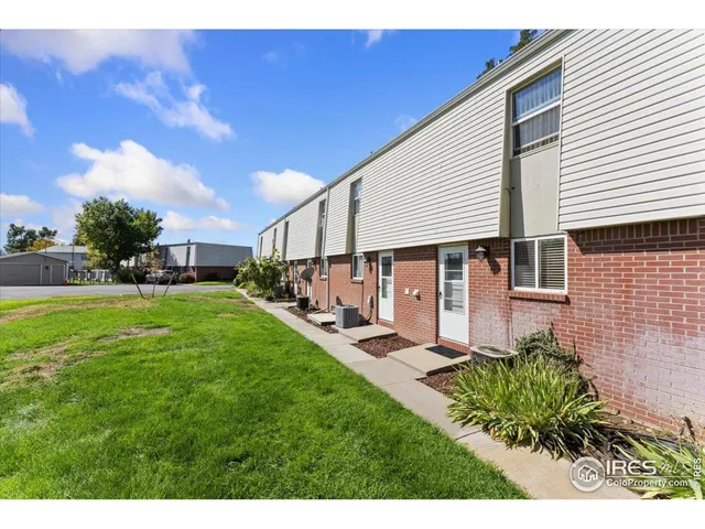 a front view of house with a garden and patio