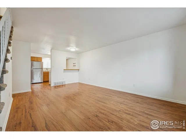 a view of an empty room and wooden floor