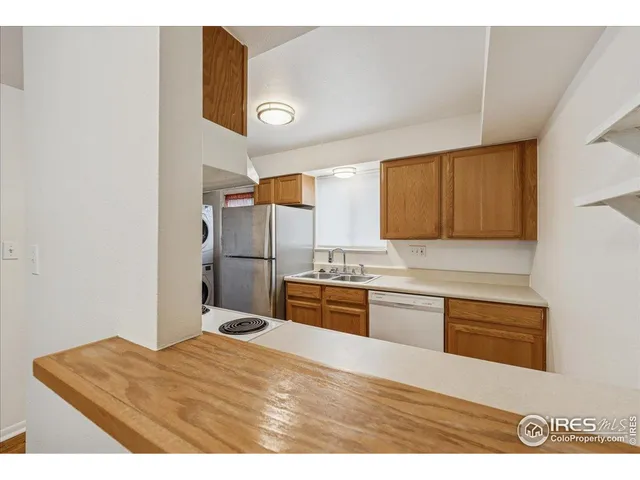 a kitchen with a refrigerator sink and cabinets