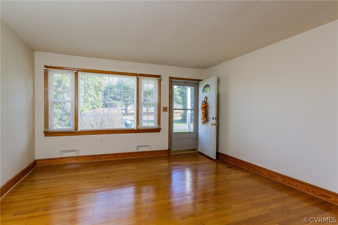 4761 Three Chopt Road Louisa, VA 23093 - Photo 4 of 32 an empty room with wooden floor and windows