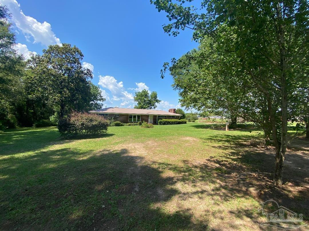 3224 Highway 4 Jay, FL 32565 - Photo 2 of 38 a view of a garden with a building in the background