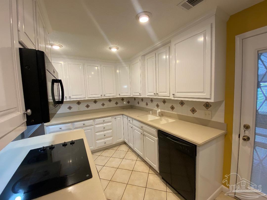 3224 Highway 4 Jay, FL 32565 - Photo 14 of 38 a kitchen with a sink dishwasher and a refrigerator