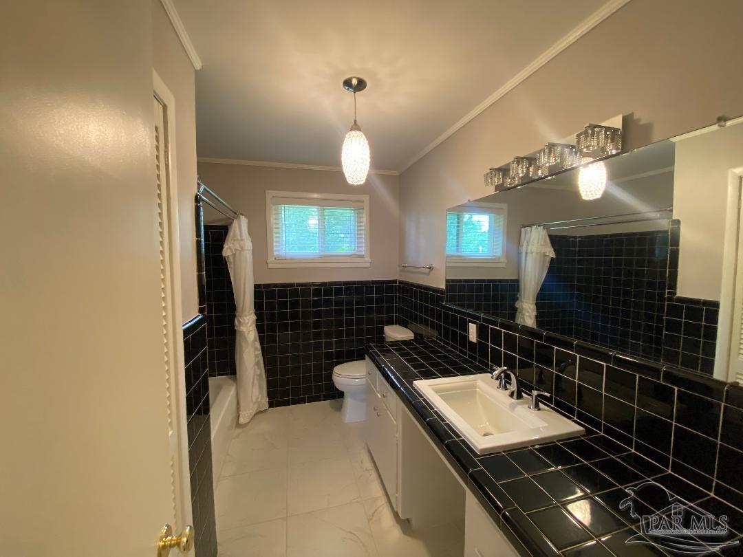 3224 Highway 4 Jay, FL 32565 - Photo 20 of 38 a bathroom with a sink a light fixture and a toilet