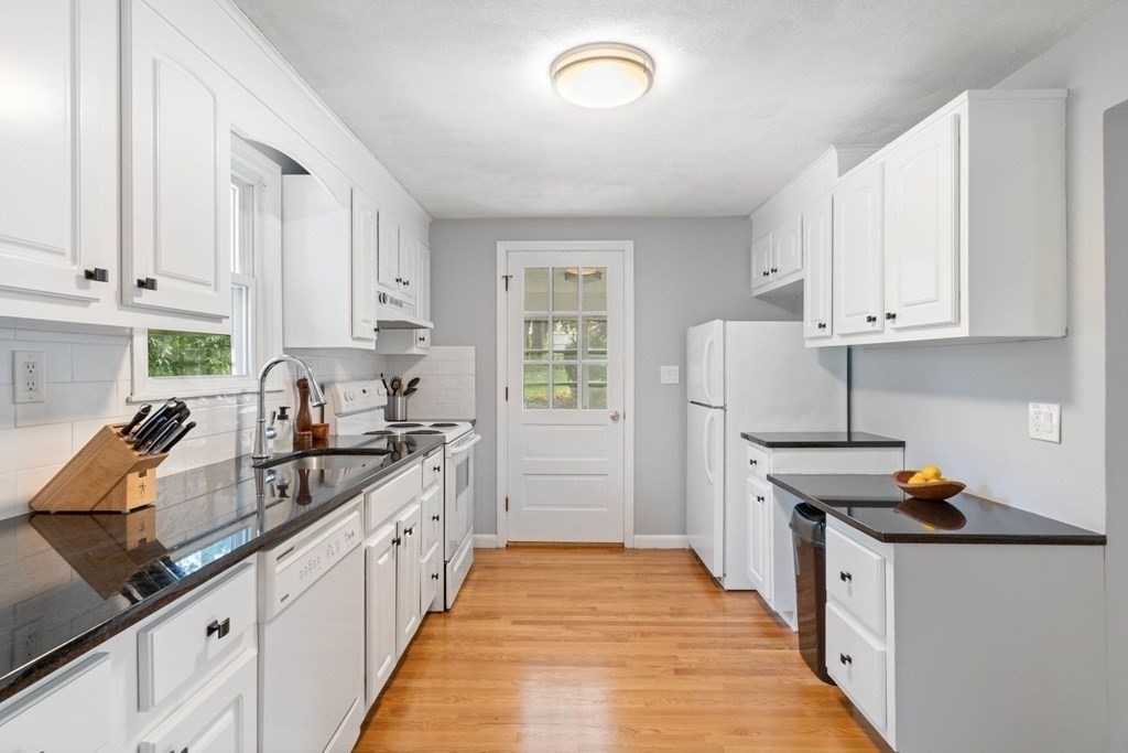 4 Rayner Circle Stoneham, MA 02180 - Photo 6 of 27 a kitchen with granite countertop a sink stove and cabinets