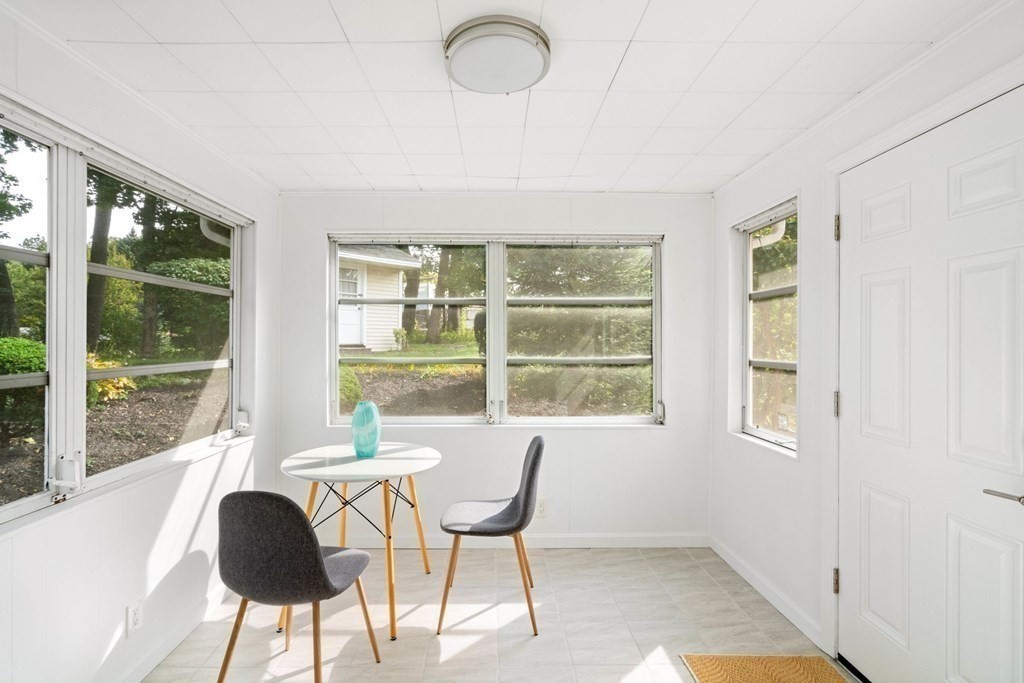 4 Rayner Circle Stoneham, MA 02180 - Photo 10 of 27 a table and chairs in a room next to a window