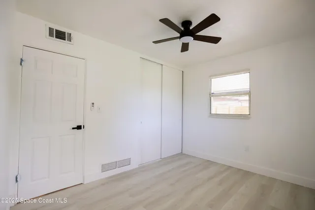 a view of a patio with a table chairs and a backyard