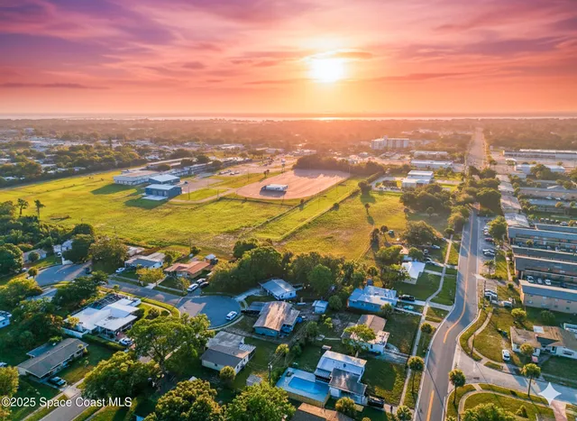 an aerial view of residential building and lake