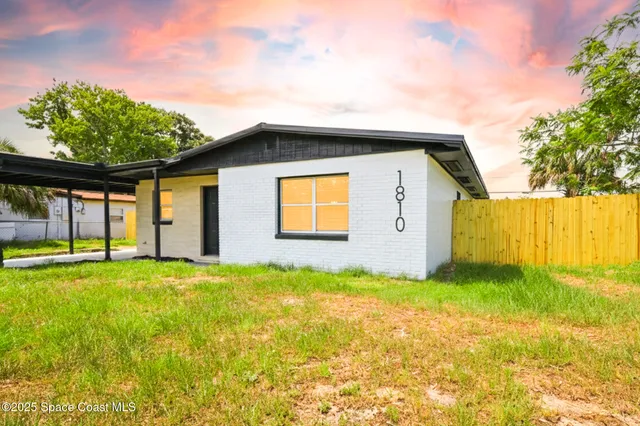 a house view with swimming pool in front of it