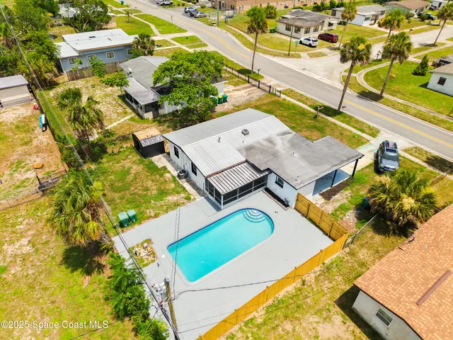 an aerial view of a house with a swimming pool
