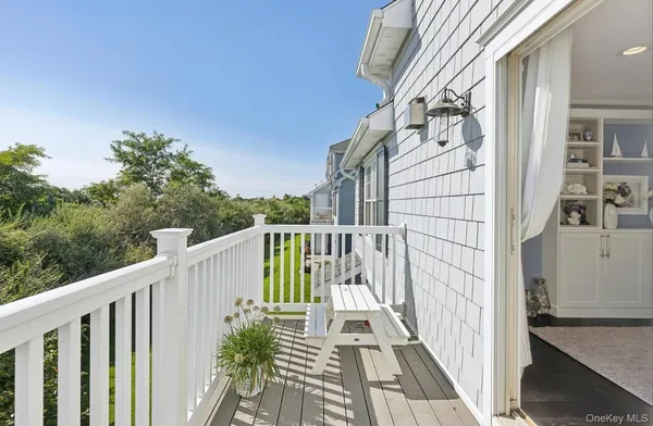 a view of a balcony with wooden floor and fence