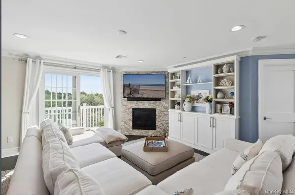 a living room with furniture fireplace and flat screen tv