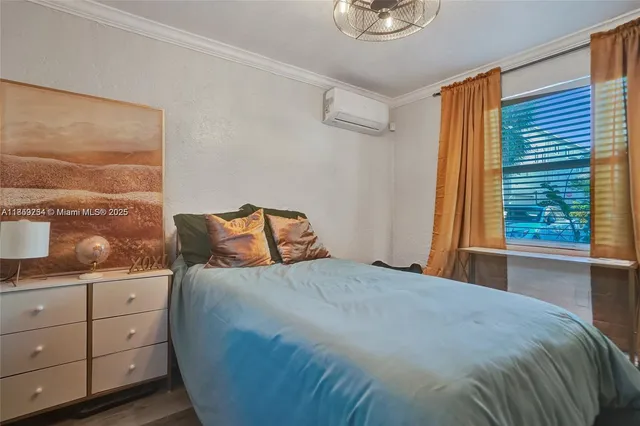 a bedroom with a bed and window