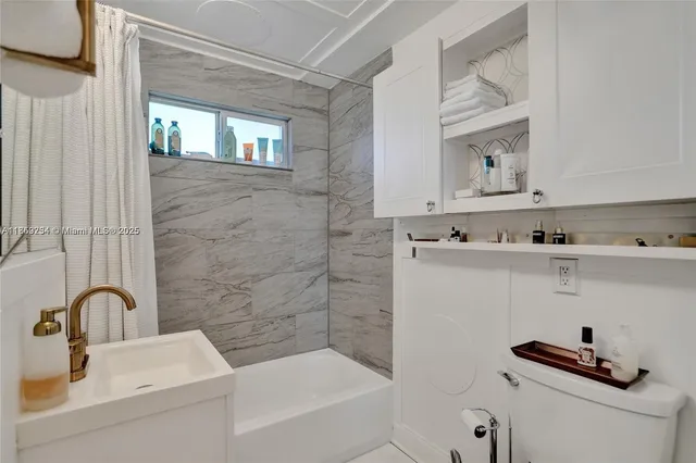 a bathroom with a sink a vanity and a bathtub