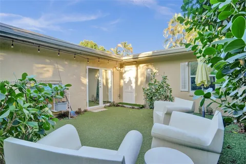 a view of a patio with couches chairs and a potted plant