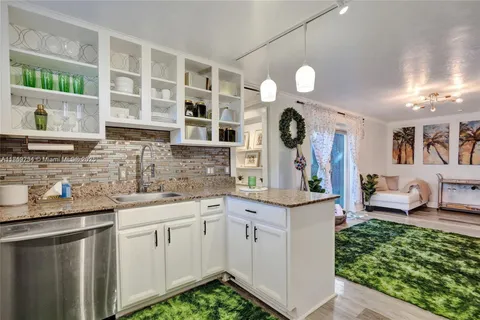 a kitchen with cabinets and window