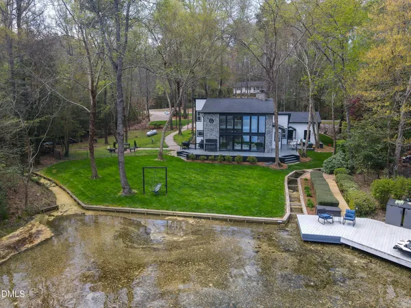 a view of a house with a garage and yard