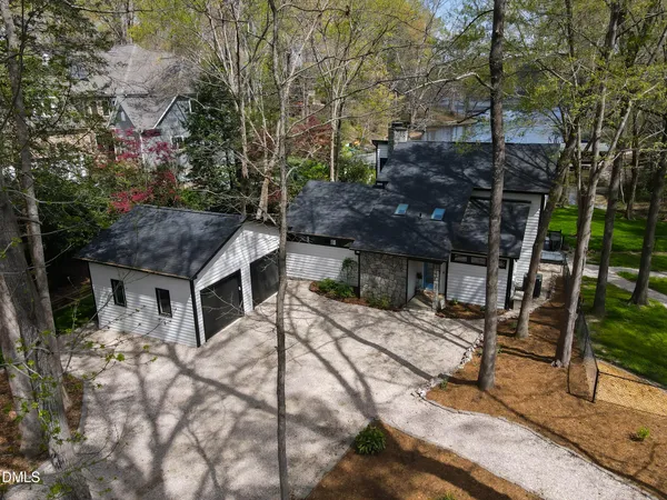 a view of a brick house with a yard and plants