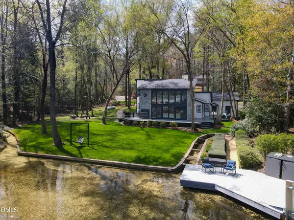 a view of swimming pool with outdoor seating and lake view