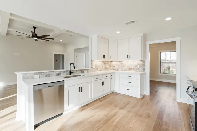 a kitchen with a stove a sink and a refrigerator