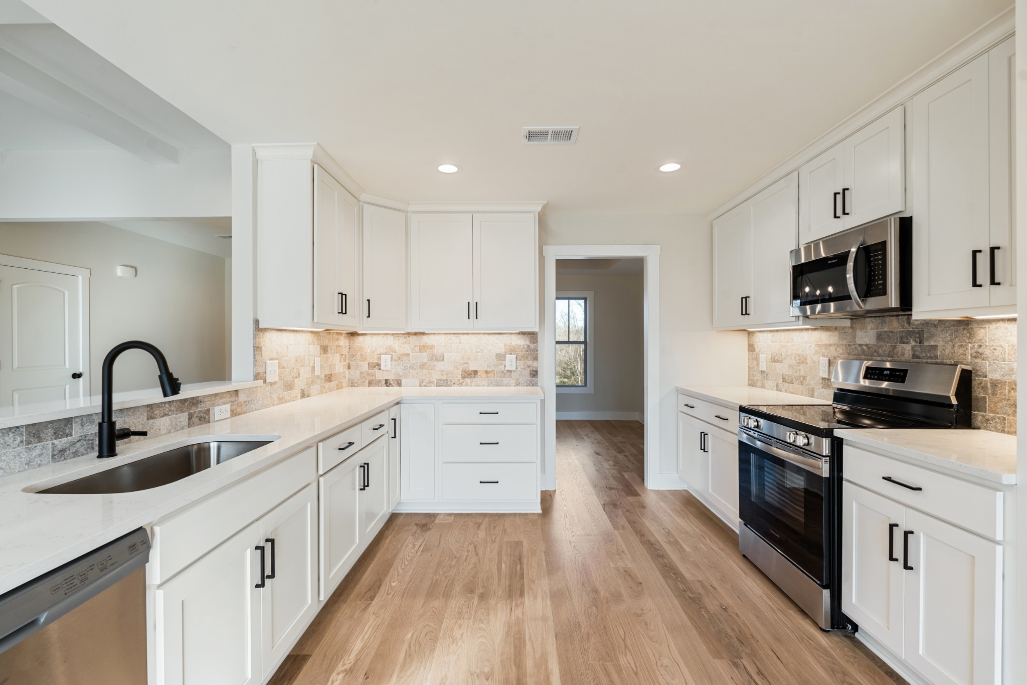 8078 Gideon Road Greenbrier, TN 37073 - Photo 12 of 26 a kitchen with white cabinets stainless steel appliances and sink